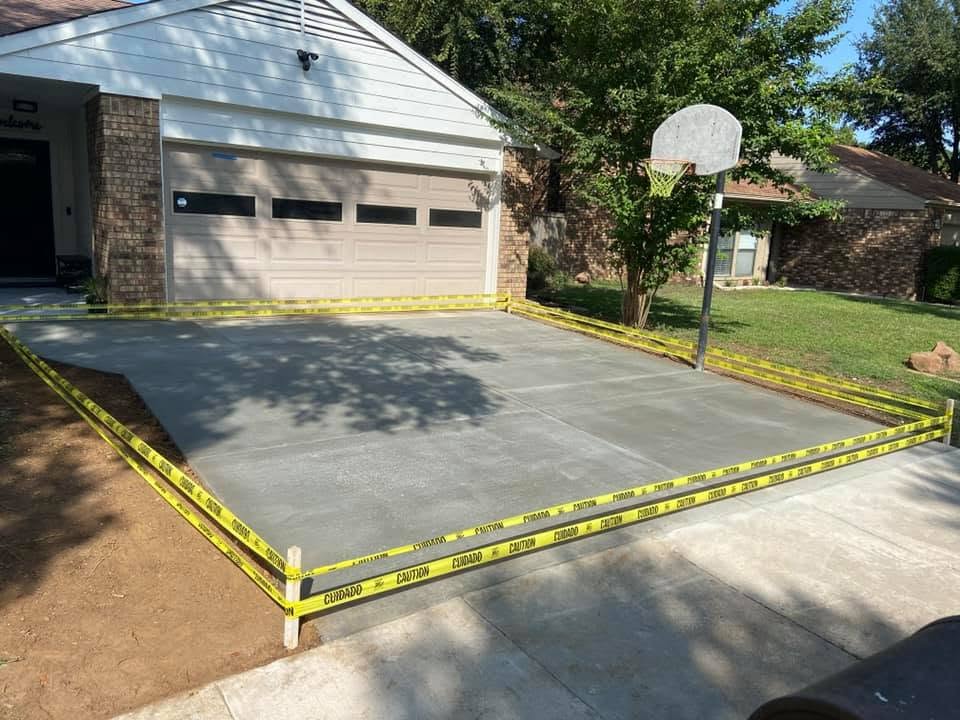 Freshly poured residential concrete driveway with caution tape curing — Horseshoe Landscaping and Construction, DFW