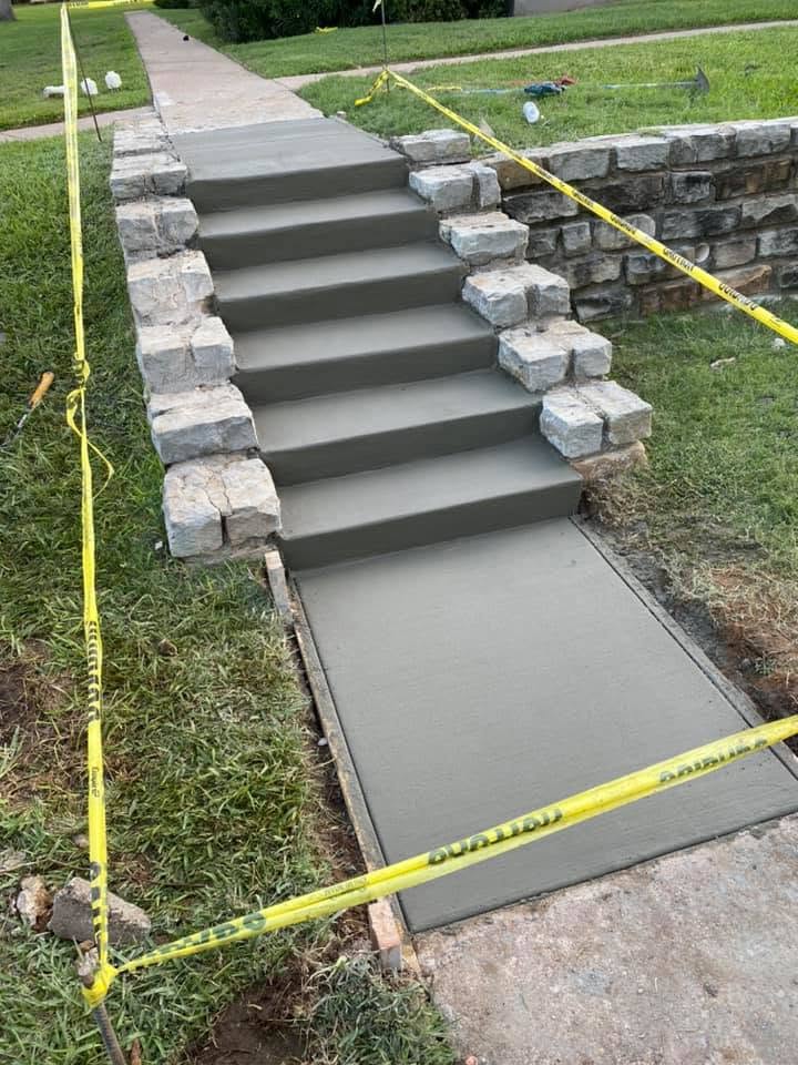 Freshly poured concrete steps with natural stone retaining wall — Horseshoe Landscaping and Construction, DFW
